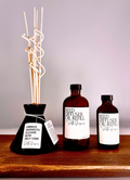 Diffuser oil in black vessel with two alt refill bottles 4oz and 8 oz